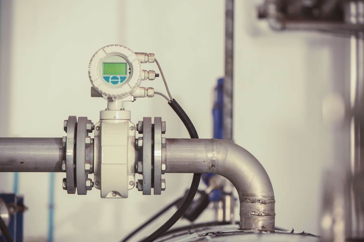 Close-up of an industrial hydrogen sensor installed on a pipeline for gas flow monitoring and leak detection.